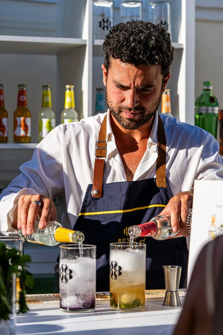 A bartender preparing drinks at an event bar