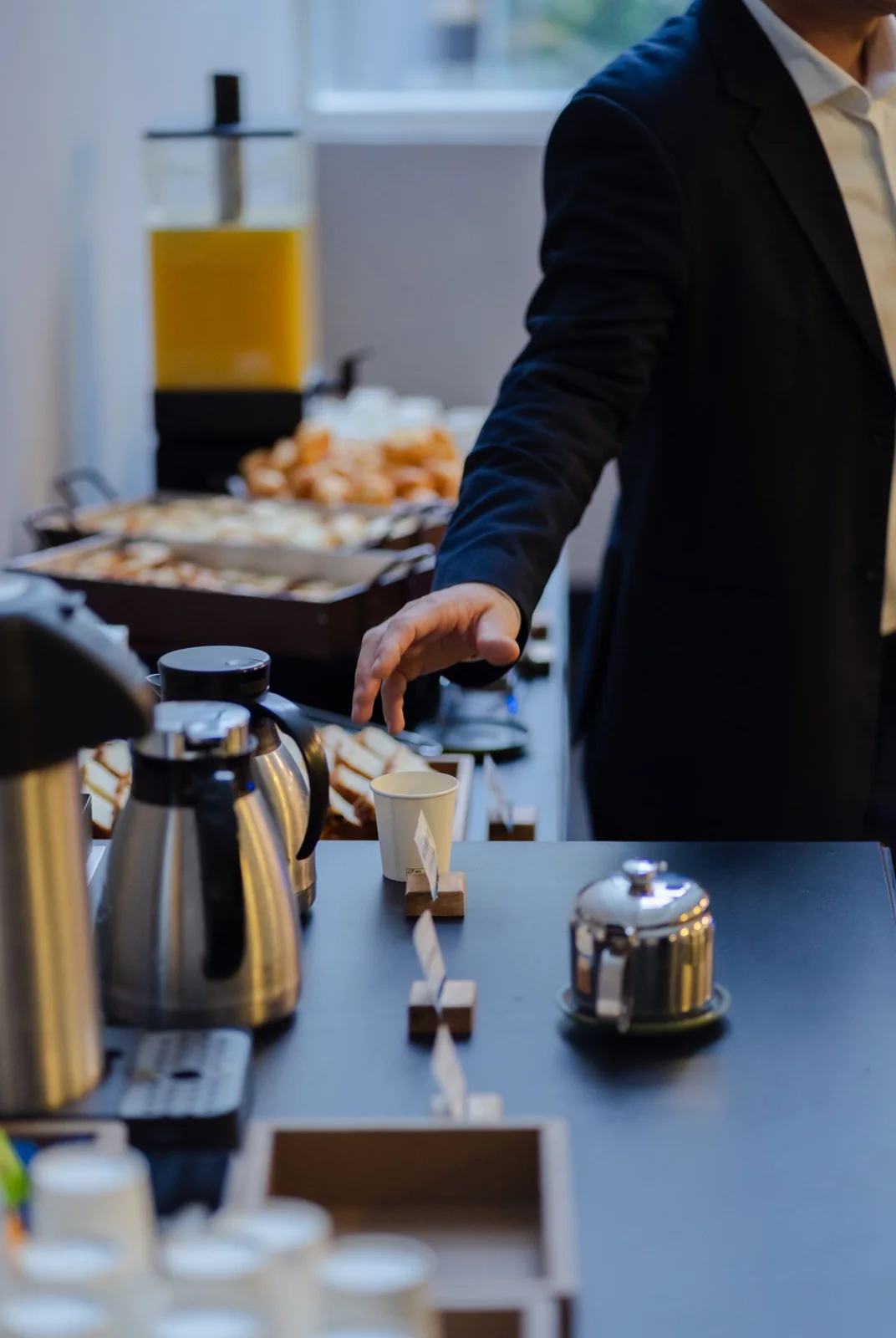 Coffee being poured at a carefully prepared business breakfast station
