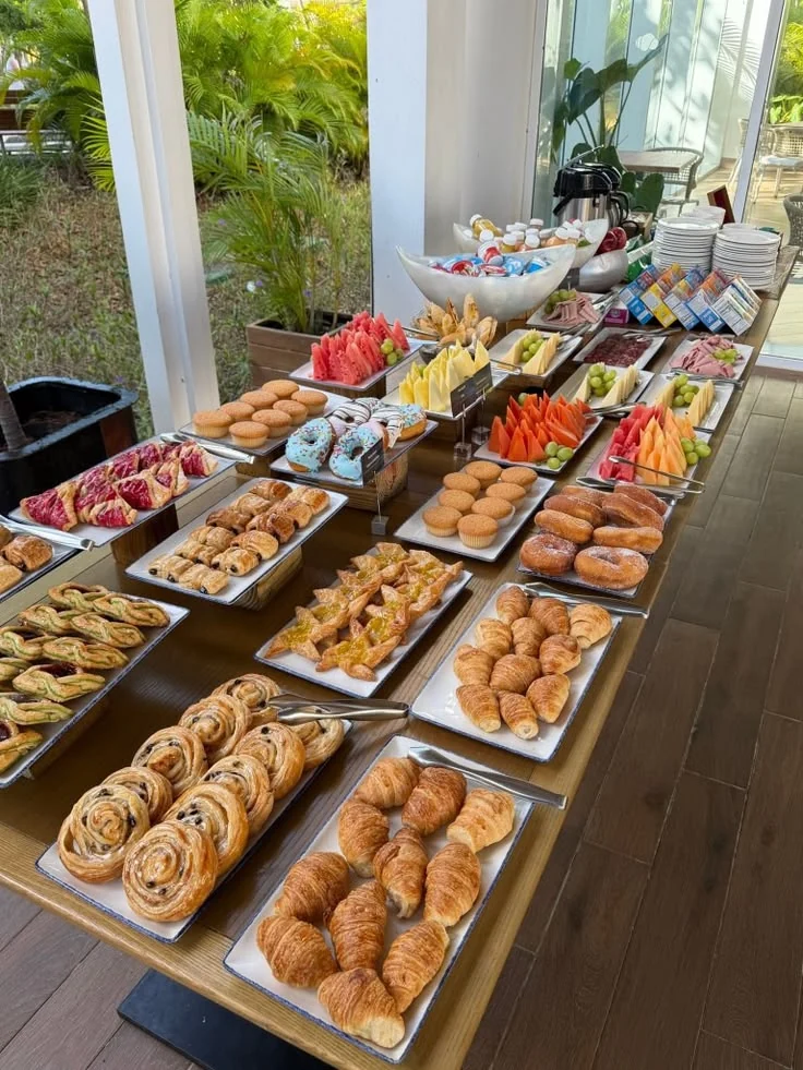 A pastry and fruit spread with coffee service